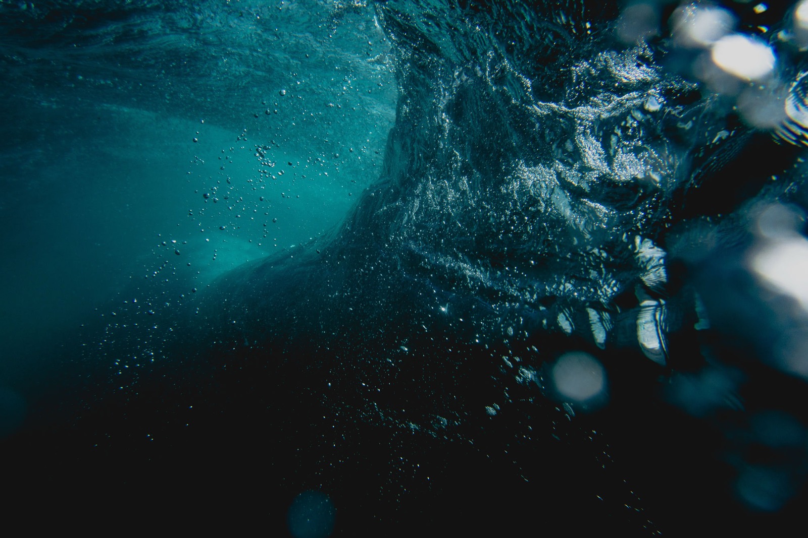 An underwater view of a breaking wave